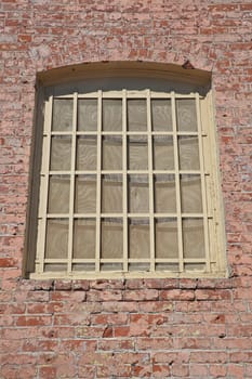 Old window in brick wall exterior