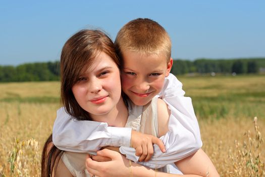 brother and sister in the summer field