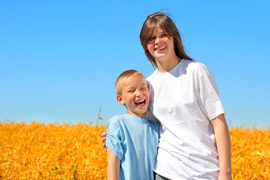 happy brother and sister in the wheat field