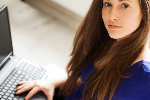 Beautiful caucasian woman relaxing at home with notebook