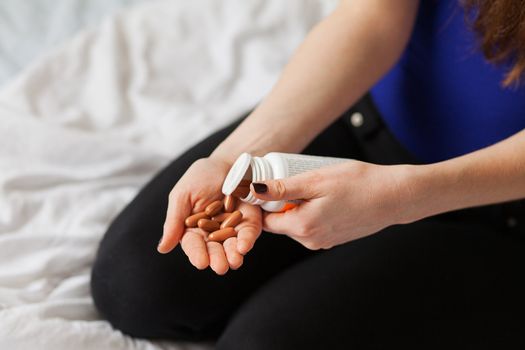 Pills lying in a white woman hands