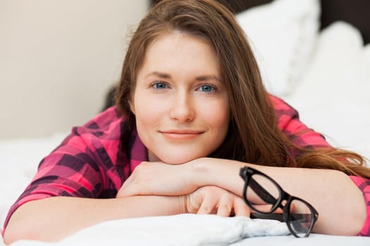 Cute young girl in casual relaxing on the bed