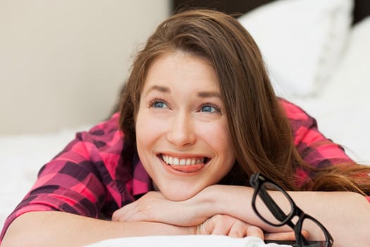 Funny young girl relaxing on the bed