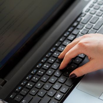 Woman near the notebooks keyboard