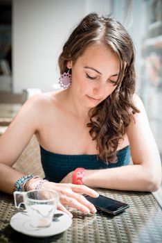 young beautiful woman on the phone at the coffee