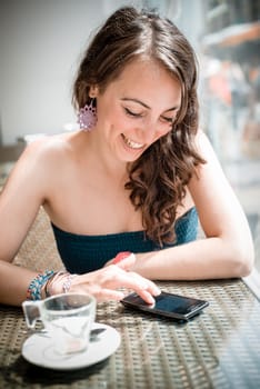 young beautiful woman on the phone at the coffee