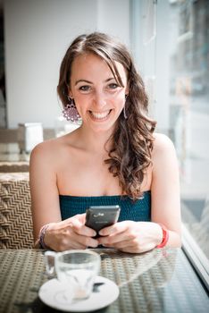 young beautiful woman on the phone at the coffee