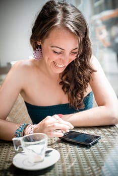 young beautiful woman on the phone at the coffee