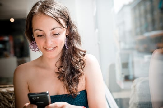 young beautiful woman on the phone at the coffee