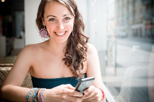 young beautiful woman on the phone at the coffee