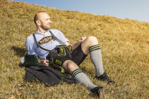 A traditional bavarian man in the autumn nature