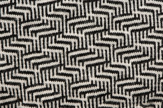 hand knit wool zigzag pattern texture black white backdrop.