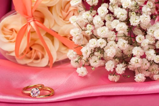  wedding rings on  a colorful fabric background