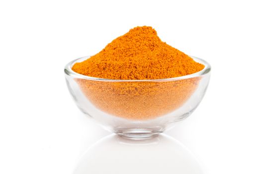 Curry spice in glass bowls, isolated on white background