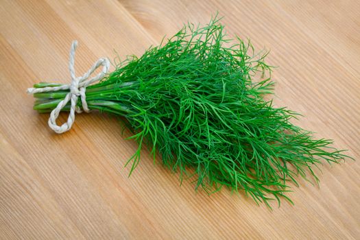 bunch fresh dill herb on wooden background