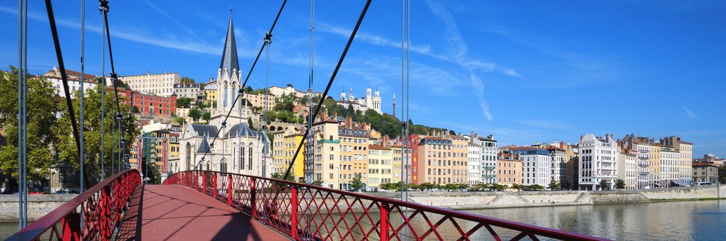 Panoramic view of Lyon city with red footbridge on Saone river