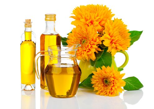 oil in glass bottle and jug with sunflowers, isolated on white