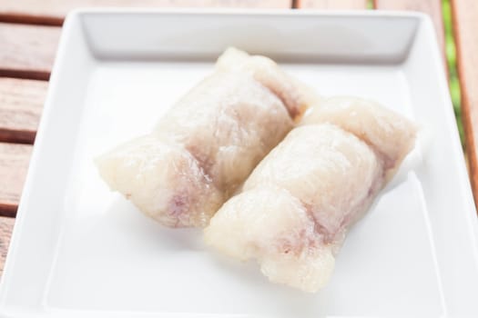 Bunch of mush with banana filling on white plate, stock photo