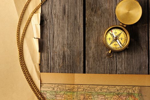 Antique brass compass over old map