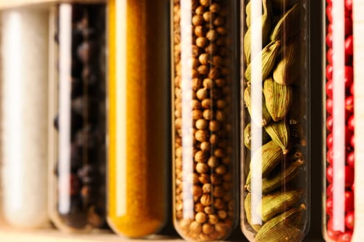 Spices in beakers against dark background