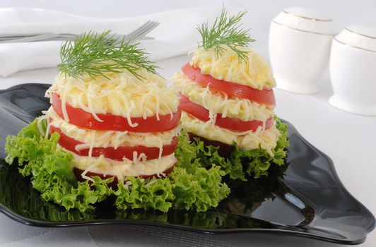 Appetizer of tomatoes stuffed with a spicy cheese and egg

