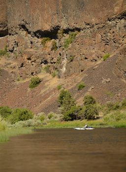 large mountain with small kayak in beautiful landscape with river in Oregon