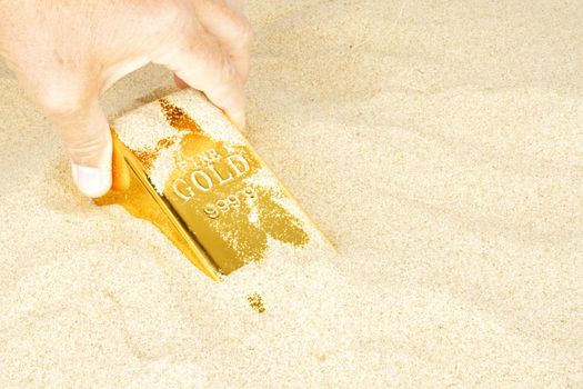Digging up a goldbar in sand