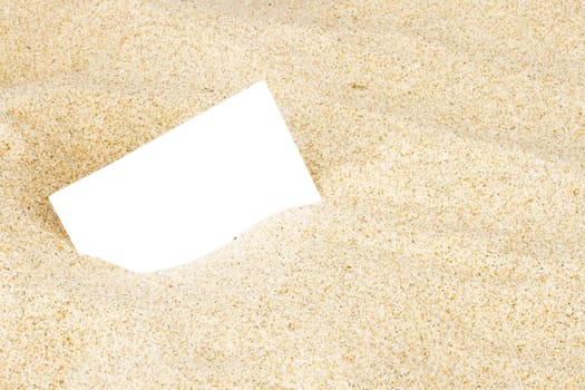 Empty business card in the sand