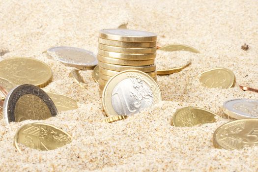 Euro coins in the sand