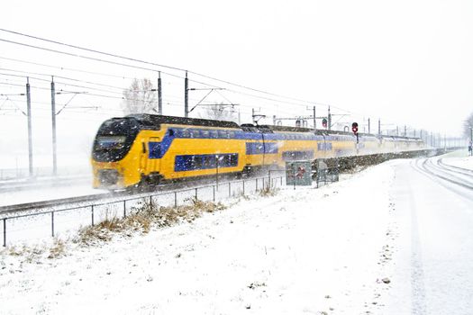 Train driving in a snowstorm in the Netherlands