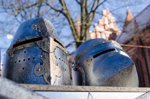 metal medieval ancient knights warrior helmets imitations sold in outdoor street market fair.