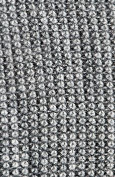 macro fragment of woollen machine knitted jacket background.