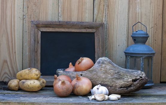 still life with wooden show onion potato and garlic