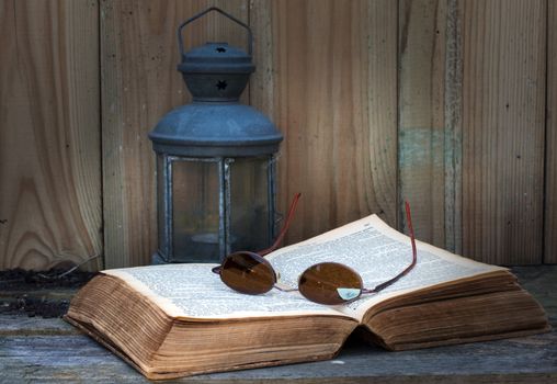 still life with old bible light and glasses