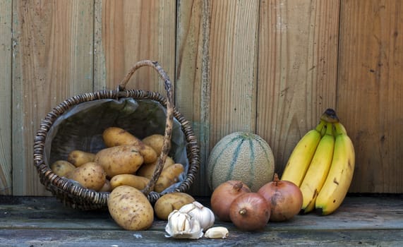 still life with bananas potato and onion
