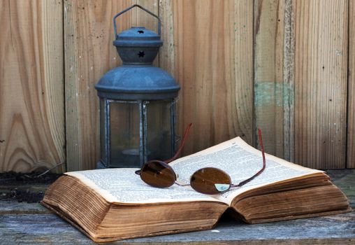 still life with old bible light and glasses