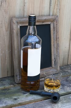 still life with whisky and a pipe