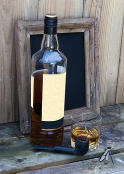 still life with bottle of whiskey and a glass