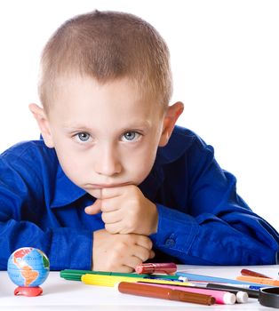 Boy thoughtfully sad thinking about school, looking at the camera isolated on a white background