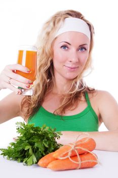 Sporty woman holding carrot juice and greens isolated on white