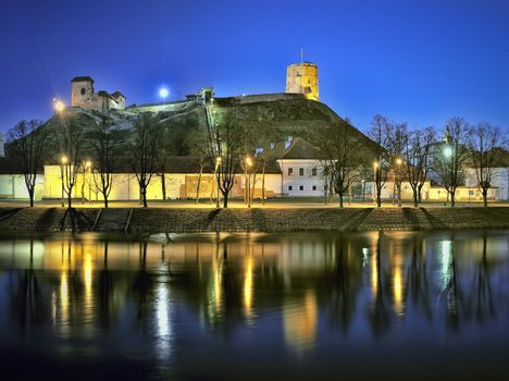 Vilnius city panorama at night - river Neris, old arsenal, Gediminas tower. Lithuania.