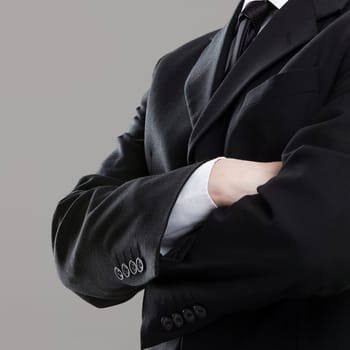 Businessman's torso in suit over grey background