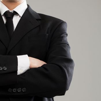 Businessman's torso in suit over grey background