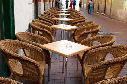 Table and wicker chairs of cafe in Valladolid, Spain