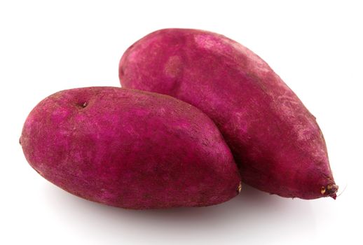 Pair of raw sweet potatoes isolated on white.