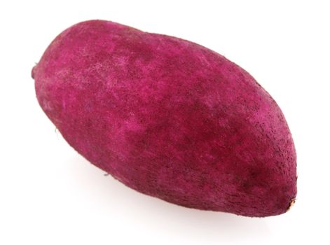 Single raw sweet potato isolated on white.