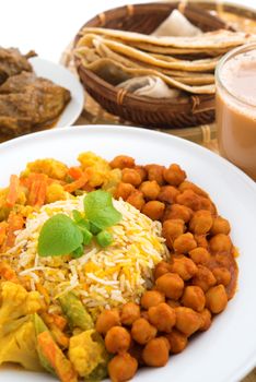 Indian food biryani rice, mutton curry, chapatti and milk tea. Indian dining table.
