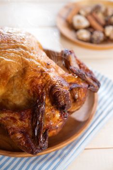 Roast chicken ready to eat on dining table.