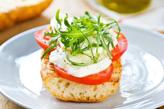 Mozzarella with tomato and rocket sandwich