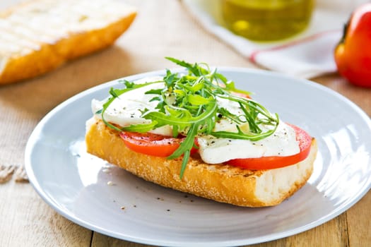 Mozzarella with tomato and rocket sandwich